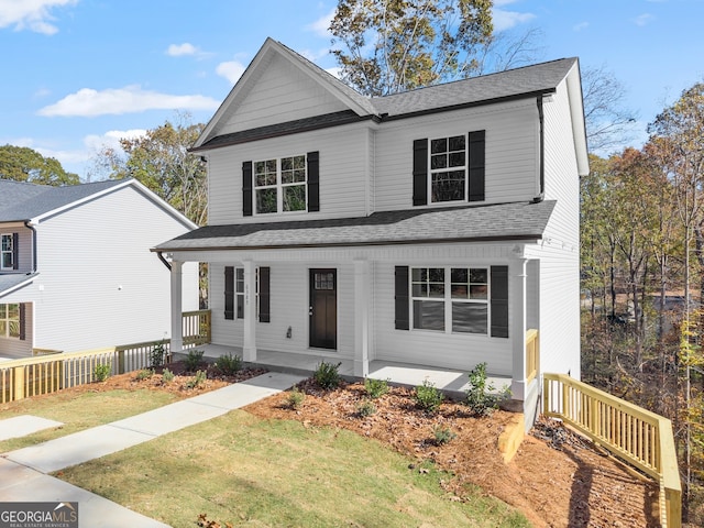 front of property with a porch and a front yard