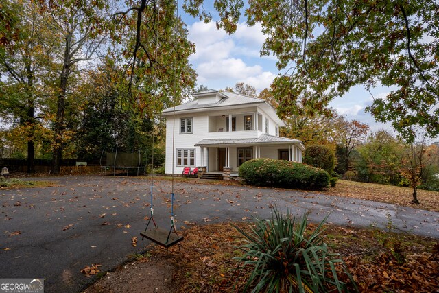 rear view of house with an outdoor structure and a garage