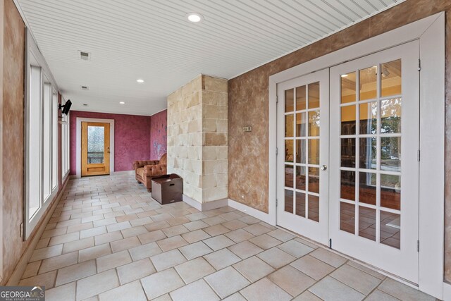 washroom featuring light tile patterned floors, washer and clothes dryer, and ornamental molding