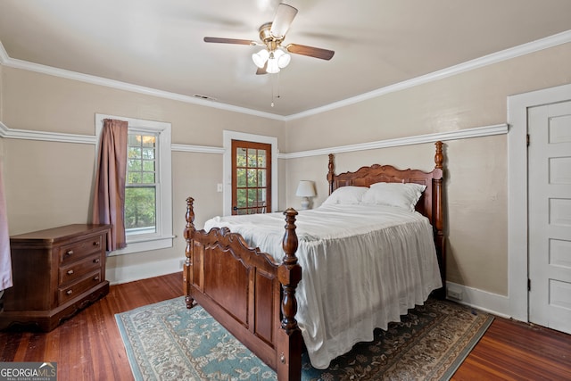 bedroom featuring dark hardwood / wood-style flooring, ceiling fan, and crown molding