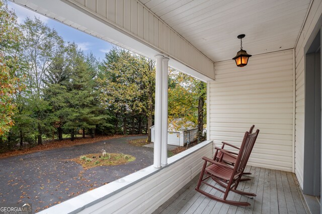 wooden terrace with a porch