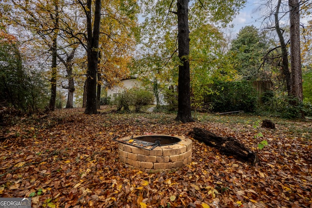 view of yard with an outdoor fire pit