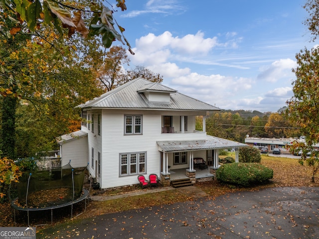 view of front facade with a porch and a trampoline