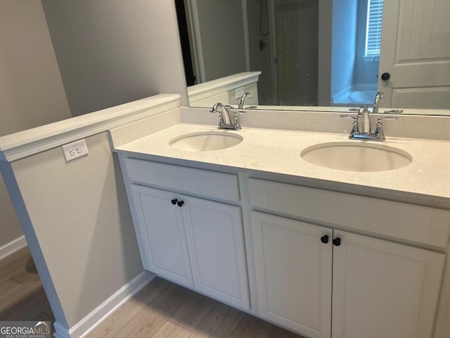 bathroom featuring hardwood / wood-style floors and vanity