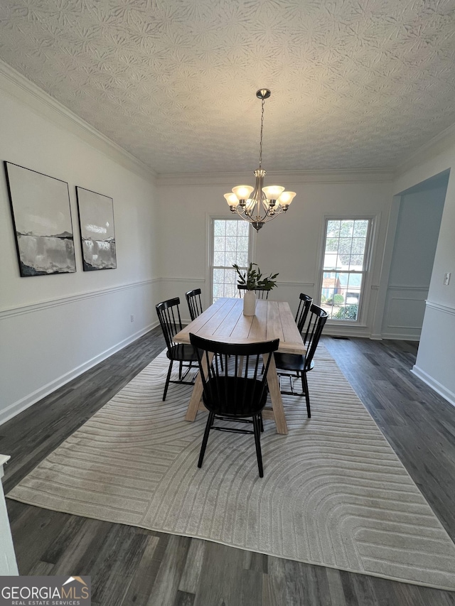 dining room with ornamental molding, a healthy amount of sunlight, an inviting chandelier, and dark hardwood / wood-style flooring