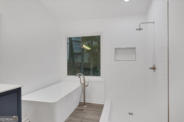 bathroom featuring hardwood / wood-style flooring, vanity, and independent shower and bath