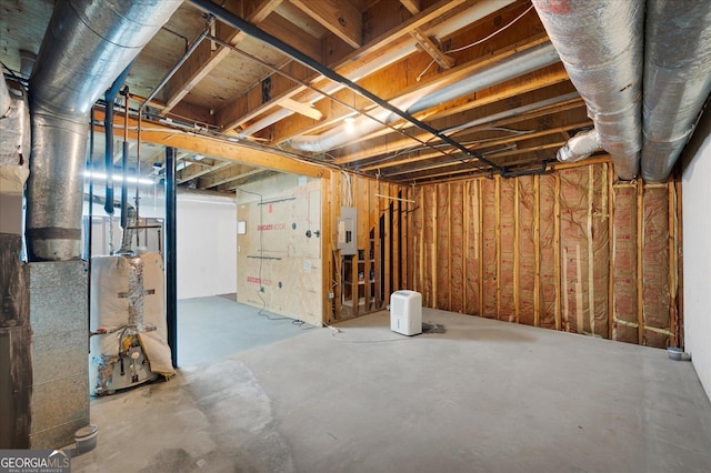 basement with gas water heater and electric panel