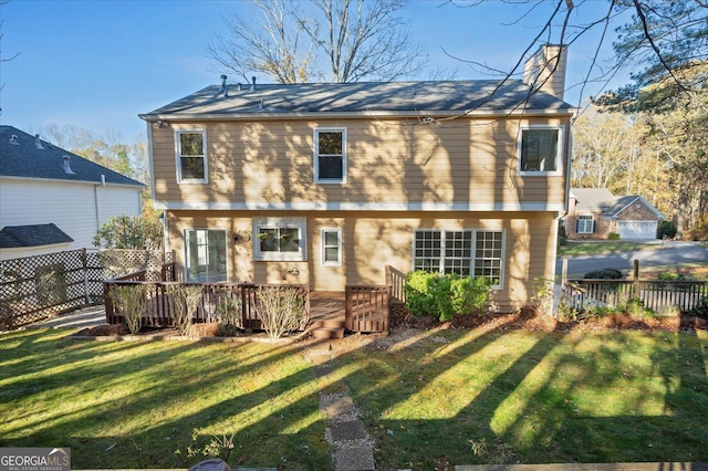 rear view of house featuring a yard and a deck