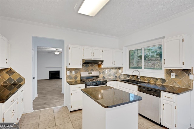 kitchen featuring appliances with stainless steel finishes, sink, a kitchen island, and white cabinets