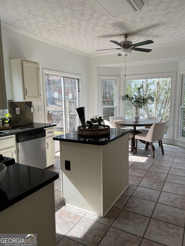 kitchen featuring white cabinets, decorative backsplash, a center island, and dishwasher