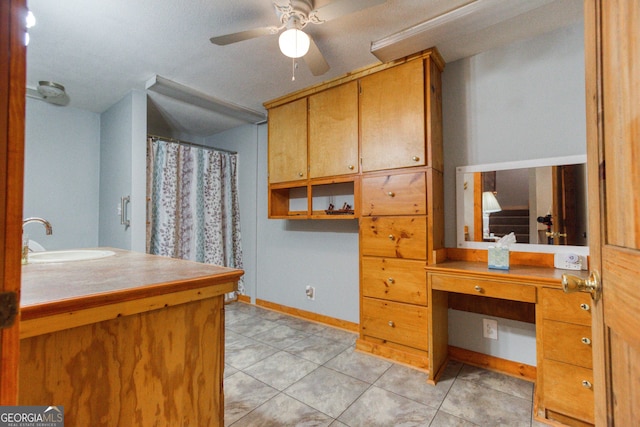 bathroom featuring ceiling fan, tile patterned flooring, and vanity