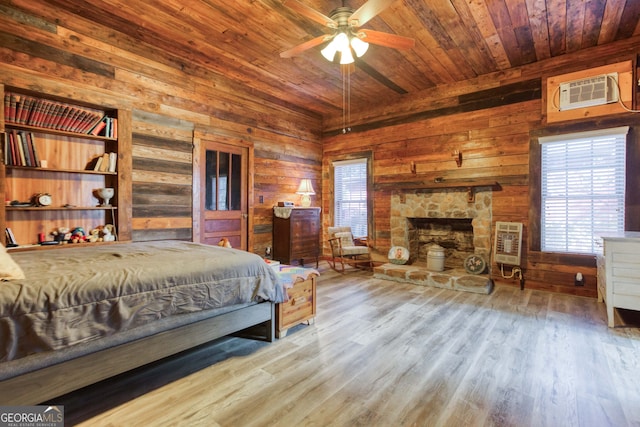 bedroom with wooden ceiling, wooden walls, light hardwood / wood-style flooring, a wall unit AC, and heating unit