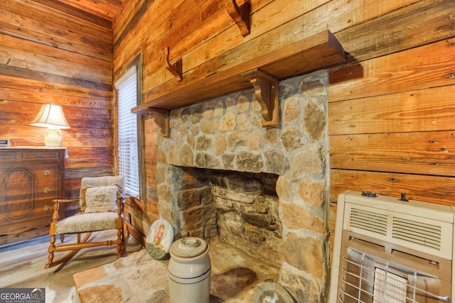 sitting room with a fireplace, hardwood / wood-style flooring, a healthy amount of sunlight, and wood walls