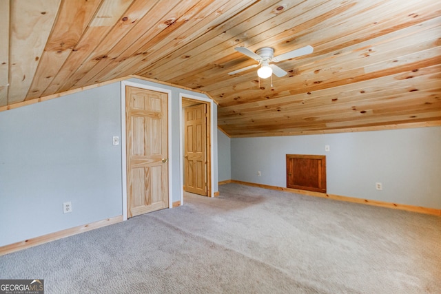 additional living space featuring light carpet, vaulted ceiling, ceiling fan, and wooden ceiling