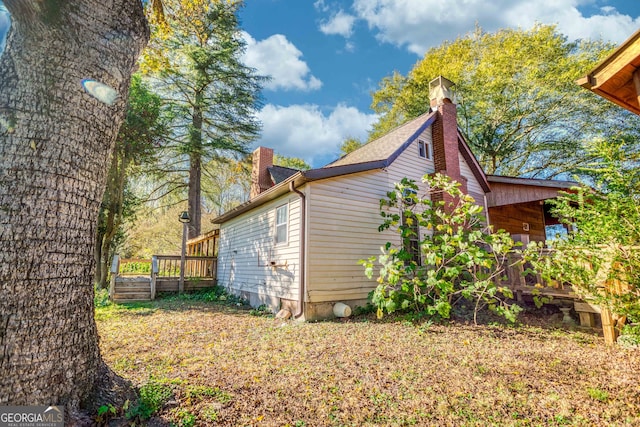 view of side of home featuring a wooden deck