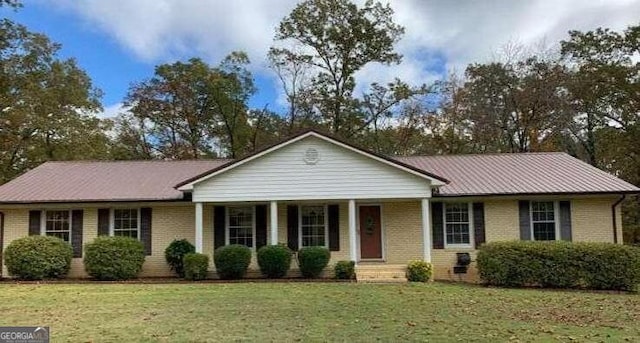 ranch-style house with covered porch and a front lawn