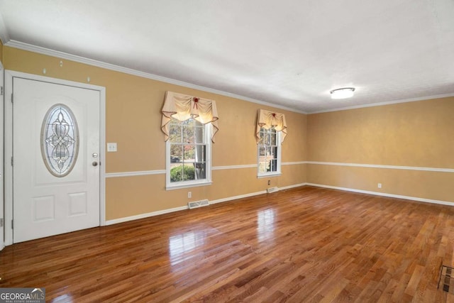 foyer with wood-type flooring and ornamental molding