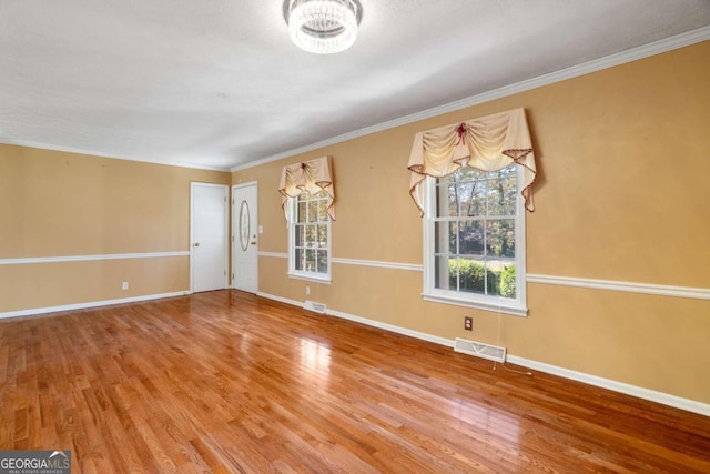 unfurnished room featuring hardwood / wood-style floors and crown molding