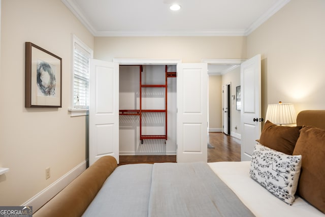 bedroom with ornamental molding, dark hardwood / wood-style flooring, and a closet