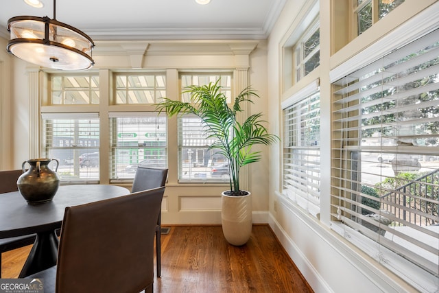 dining space with ornamental molding and dark hardwood / wood-style flooring