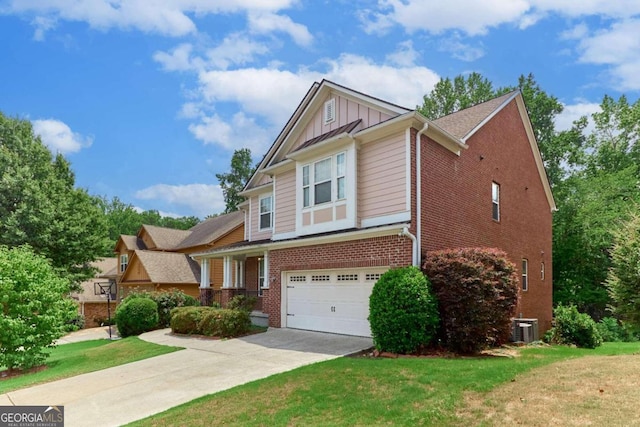 view of front of house with central AC, a front yard, and a garage