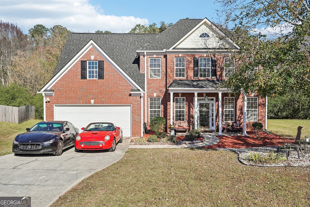 view of front of home featuring a front lawn and a garage