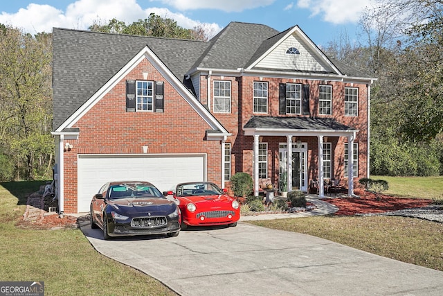 view of front of property with a garage and a front lawn