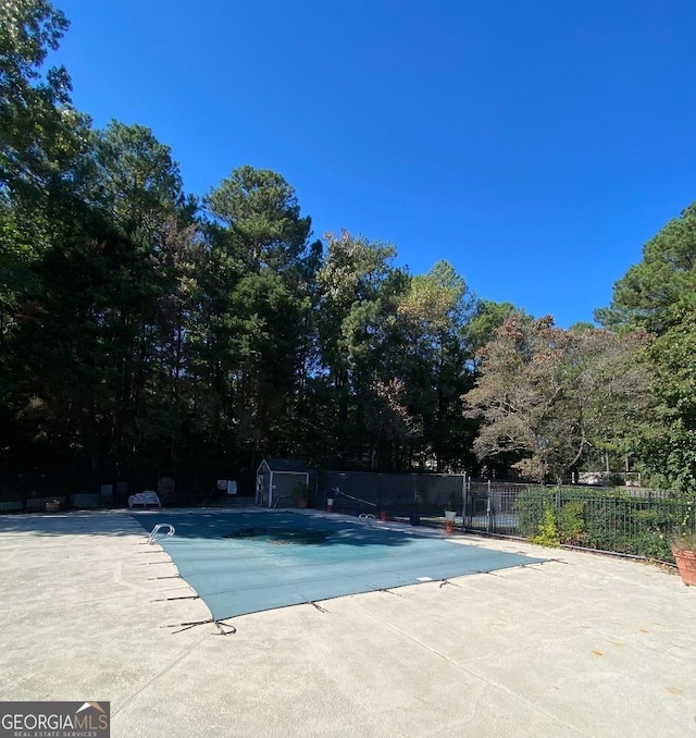 view of swimming pool featuring a patio area