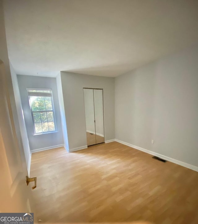 unfurnished bedroom featuring light wood-type flooring