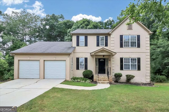 view of front of property with a front lawn and a garage