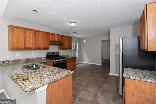 kitchen featuring kitchen peninsula, light stone countertops, and appliances with stainless steel finishes