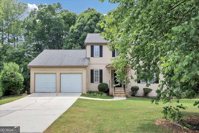 colonial inspired home featuring a front yard and a garage