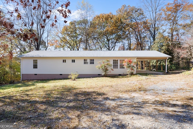 single story home with a front lawn and a carport