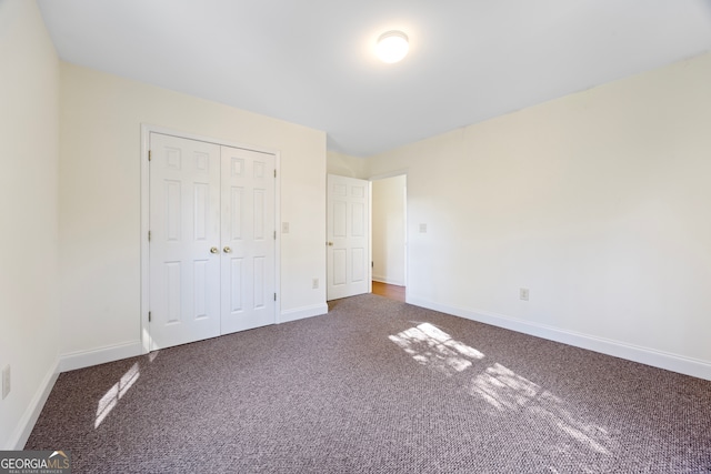 unfurnished bedroom featuring carpet floors and a closet