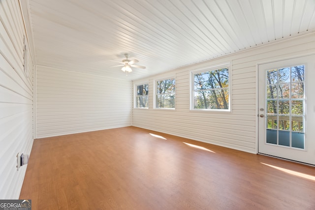 unfurnished sunroom featuring ceiling fan and wooden ceiling