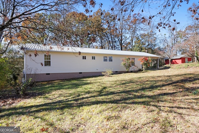 rear view of property featuring a yard