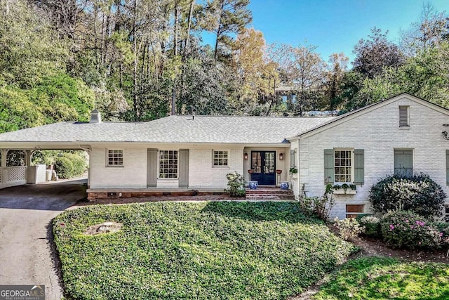 ranch-style home featuring a carport