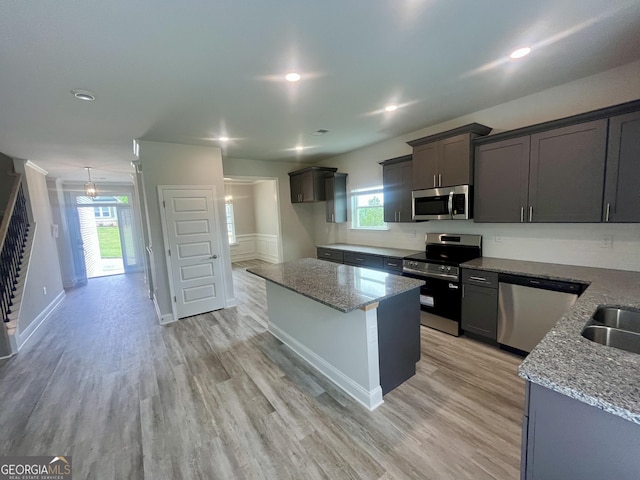 209 Shoreline Way Lot A19, Plan, Macon, GA 31220 - kitchen with appliances with stainless steel finishes, light stone countertops, light wood-type flooring, a kitchen island, and recessed lighting
