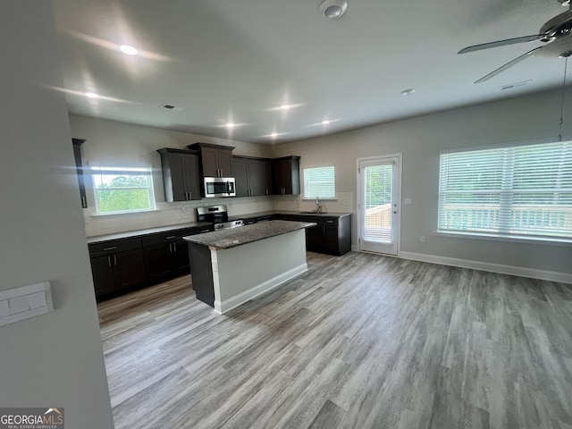 209 Shoreline Way Lot A19, Plan, Macon, GA 31220 - kitchen featuring appliances with stainless steel finishes, a ceiling fan, backsplash, light wood-style floors, and plenty of natural light