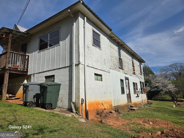 view of side of home with a yard