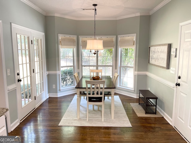 dining room featuring dark hardwood / wood-style floors, a wealth of natural light, and crown molding