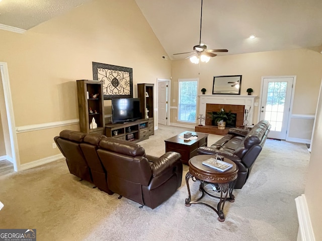 living room with ceiling fan, high vaulted ceiling, and light carpet