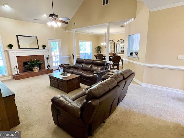 living room with light colored carpet, ceiling fan, crown molding, high vaulted ceiling, and a fireplace