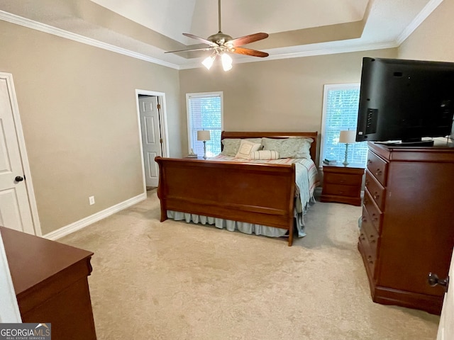 carpeted bedroom featuring a tray ceiling, ceiling fan, and ornamental molding