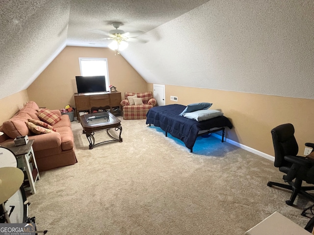 carpeted bedroom featuring ceiling fan, a textured ceiling, and vaulted ceiling