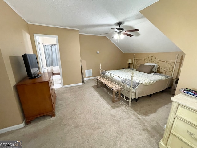 carpeted bedroom featuring connected bathroom, ceiling fan, crown molding, lofted ceiling, and a textured ceiling