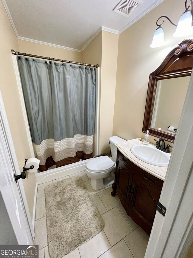 bathroom with tile patterned flooring, vanity, toilet, and crown molding