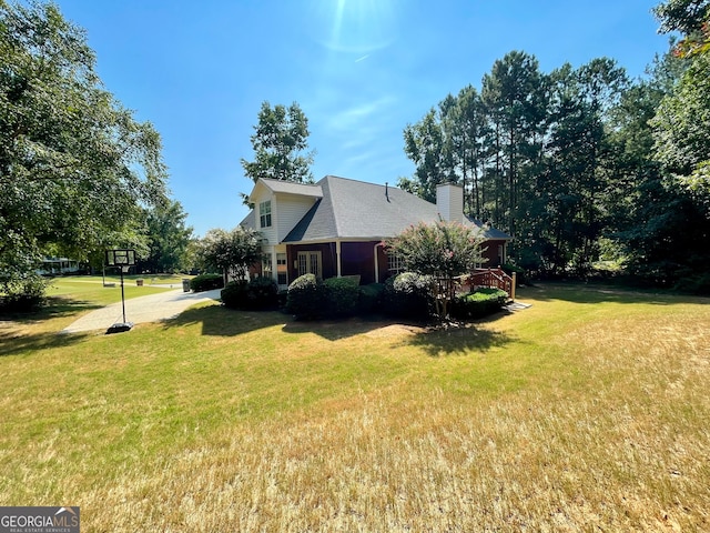 view of side of home with a yard