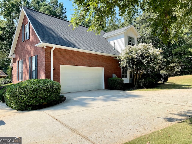 view of side of home featuring a garage