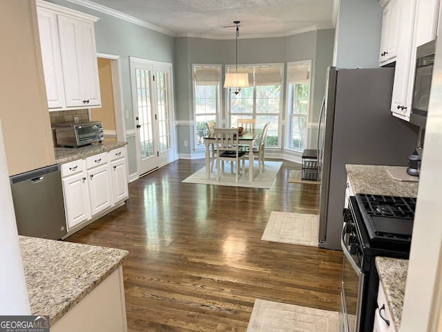 kitchen featuring white cabinets, decorative light fixtures, dark hardwood / wood-style floors, and stainless steel appliances